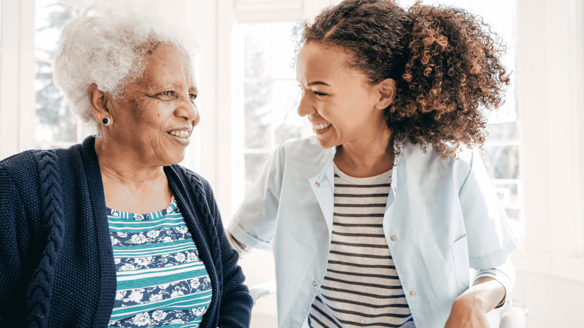 senior caregiver laughing with client
