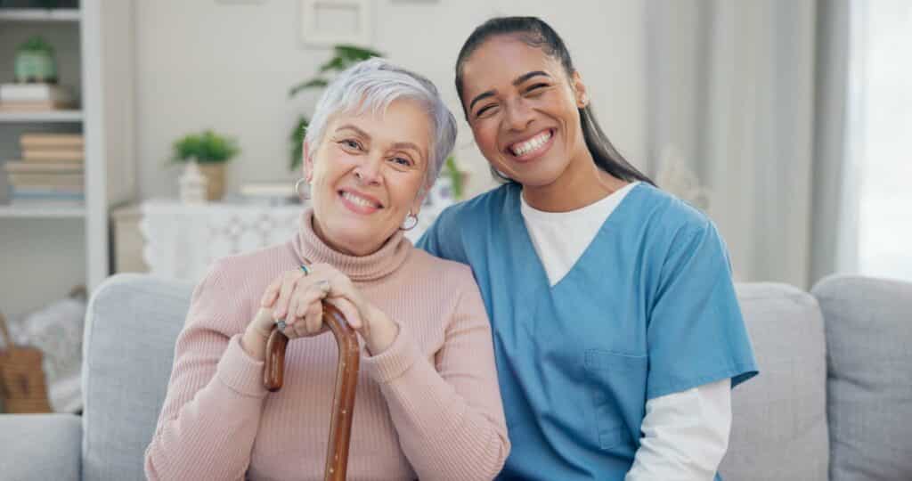 care giver sitting with an elderly woman